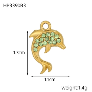 Detailed view of 1.3cm gold dolphin pendant featuring micro-set green cubic zirconia