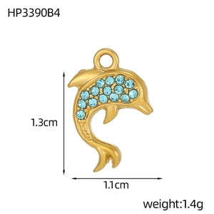 Macro shot of gold dolphin pendant with blue crystals and measurement details