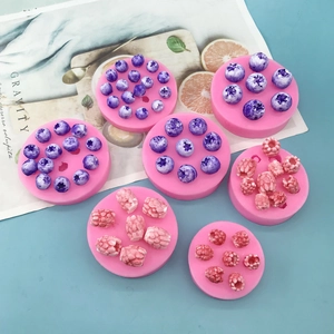 Pink silicone fruit mold set for realistic blueberry and raspberry fondant decorations