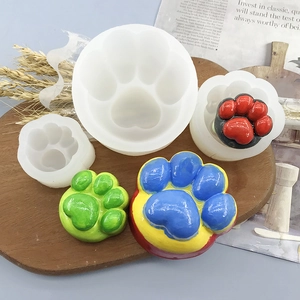 Food grade silicone molds for cat paw DIY crafts displayed on a wooden tray with finished models