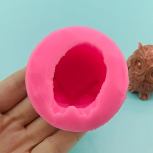 Pink silicone owl mold for making 3D candles and chocolate, shown with finished figure