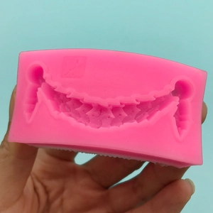 Pink silicone mold featuring hanging garland patterns for DIY cake fringe decoration