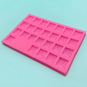 Pink silicone mold featuring 26 uppercase alphabet letters for cake and chocolate decorating