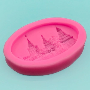 Pink silicone mold with 3D castle design for cake decorating and soap making