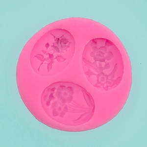 Detailed macro view of pink silicone flower mold with three floral relief patterns