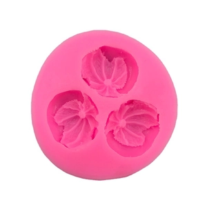 Pink silicone fruit mold featuring three detailed orange leaf shapes for cake decorating
