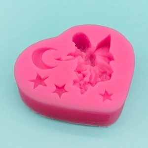Pink heart-shaped silicone mold featuring embossed moon star and fairy fairy angel patterns