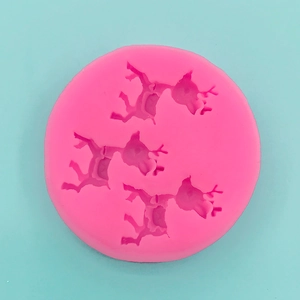 Detailed top view of pink silicone mold featuring three reindeer for DIY cake and chocolate