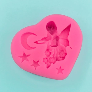 Macro view of heart-shaped silicone mold featuring fairy, crescent moon and star patterns