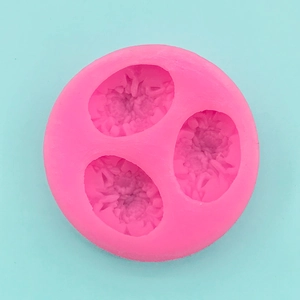 Macro shot of 3-cavity pink silicone mold with detailed rose floral texture for DIY craft