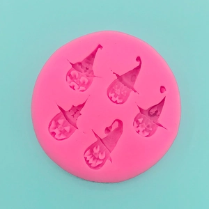 Pink silicone pumpkin mold with five detailed gnome cavities for Halloween baking and DIY