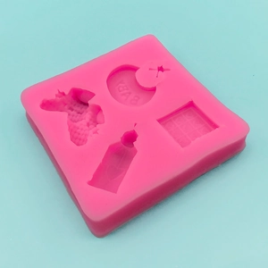 Pink silicone mold featuring baby theme shapes like bottles, unicorns, and BABY lettering