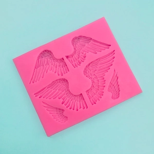 Close-up of pink silicone angel wings mold for fondant and chocolate crafts
