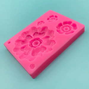 Pink silicone flower mold with four floral patterns for fondant or chocolate decoration