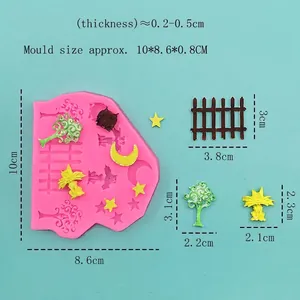 Pink silicone mold featuring star moon fence shapes with finished DIY cake toppers