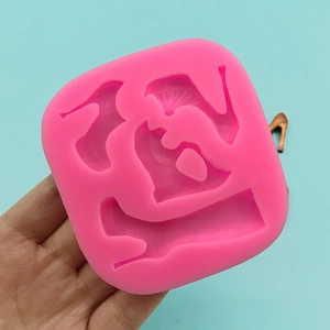 Pink silicone mold featuring high heel shoes and folding fan shapes for cake decorating