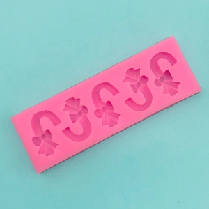 Detailed view of pink silicone Christmas candy cane mold for fondant and DIY baking decor