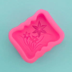Macro detail of pink silicone mold featuring three intricate narcissus flower patterns