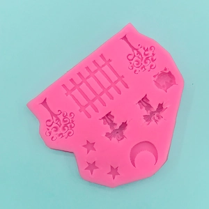 Pink silicone mold featuring moon, stars, and fence shapes for fondant and cake decoration