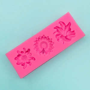 Detail of pink silicone mold featuring sunflower and lily shapes for DIY baking and crafts