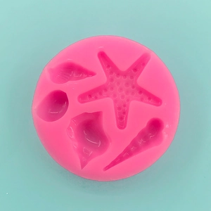 Detail of pink silicone mold featuring starfish, seashells, and sea snails for DIY crafts