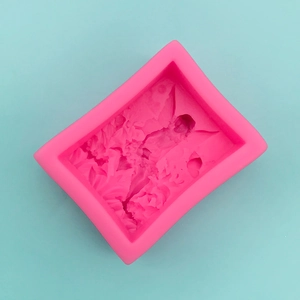 Detailed relief of angel girl and flowers on pink silicone mold for DIY crafts