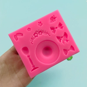 Pink silicone mold featuring bow, rose, and leaf designs for fondant cake decoration