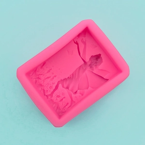 Detailed close-up of a pink silicone mold showing a 3D fairy girl relief for DIY projects