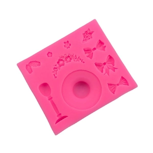 Pink silicone mold featuring 3D bowknot, rose leaf, and flower designs for DIY cake baking