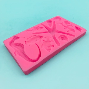Pink silicone mold featuring seahorse, starfish, and seashell shapes for cake DIY