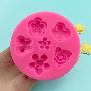 Pink silicone mold with butterfly and rose flower patterns for fondant and DIY crafts