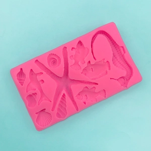 Macro shot of pink silicone mold with sea creatures like seahorses, shells and starfish