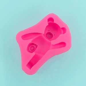Macro detail of pink bear silicone mold showing facial features and paw pad textures