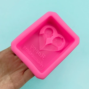 Pink heart-shaped silicone mold with Happy Anniversary text and couple silhouette