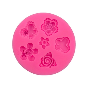 Pink silicone mold with 6 cavities featuring detailed flower and butterfly patterns