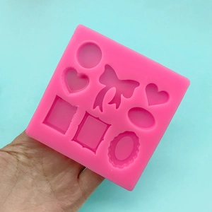 Pink silicone mold with bow and heart shapes for DIY cake decorating and fondant art