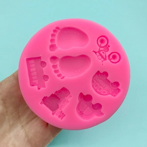 Pink silicone mold with car, bus, and baby footprint patterns for cake decorating