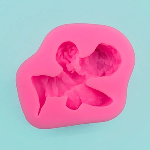 Detailed macro view of pink flexible silicone mold with intricate floral relief patterns
