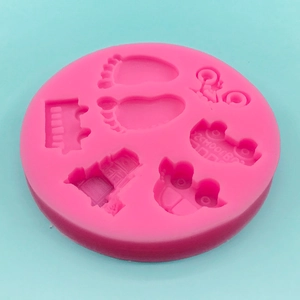 Pink silicone DIY mold featuring school bus, bicycle and baby footprints for cake decoration
