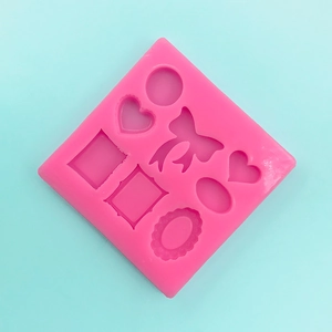 Detailed pink silicone mold for DIY fondant featuring hearts and bow tie shapes