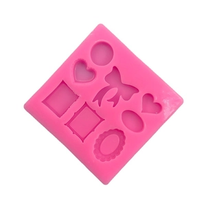Pink silicone mold with heart, bow, and frame shapes for DIY cake decor and fondant crafts