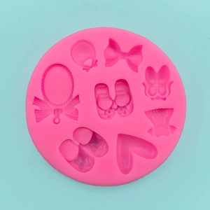 Detailed macro view of pink silicone mold with bow, heart, and ballet dress shapes