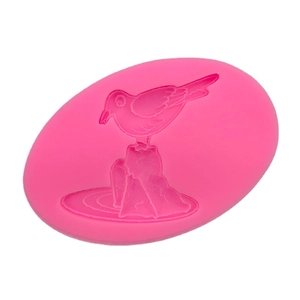 DIY silicone mold for baking and resin featuring a bird on a stone bird landscape design