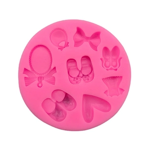 Pink silicone baby theme mold with heart, bow, and shoes shapes for cake decoration