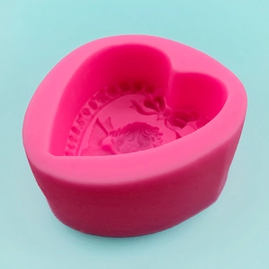 Pink heart-shaped silicone mold with angel and bow relief for soap and fondant making