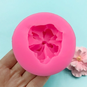 Pink cherry blossom silicone mold for fondant and chocolate decoration on blue background