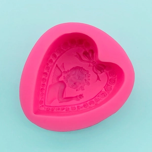Detail of heart silicone mold with angel and rose pattern for fondant and soap making