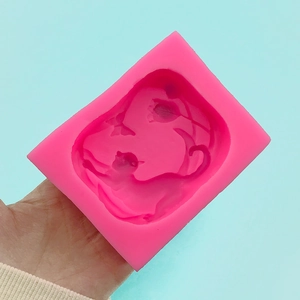 Pink silicone mold featuring 3D cartoon cat and butterfly flower patterns for DIY crafts