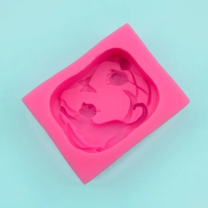 Detailed top view of pink silicone mold featuring 3D cat and flower relief for DIY crafts