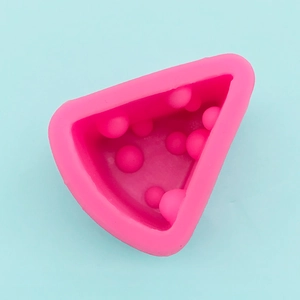 Top view of pink triangle silicone mold with polka dots for cheese cake and jelly crafts